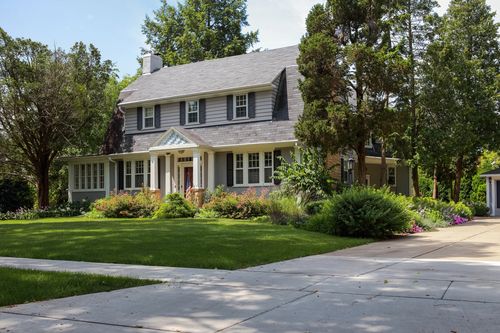 Image is of a traditional home with new roof concept of Atlanta roofing contractors