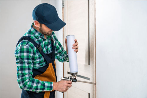 Contractor installing energy-efficient door